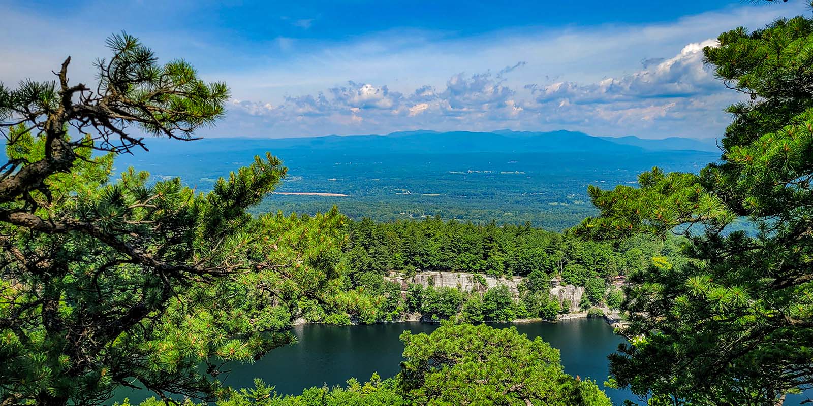 Photo of a lake and valley with mountains in the distance